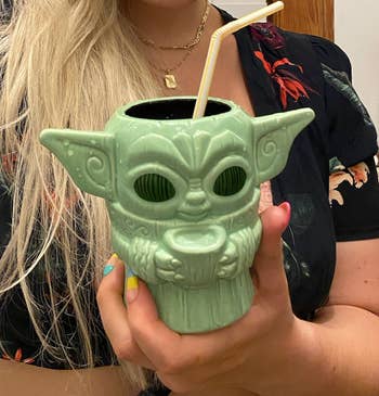 reviewer image using the Baby Yoda mug to hold a drink