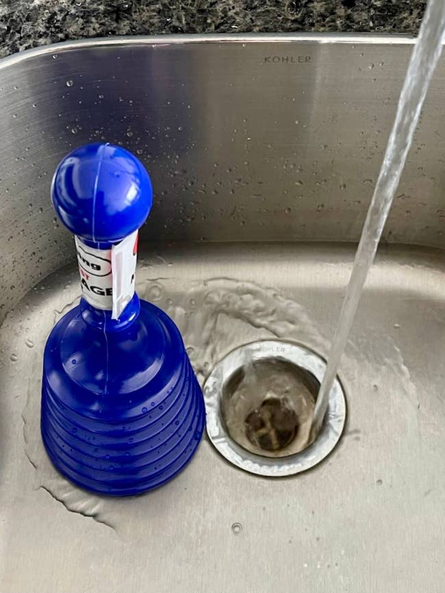 a small blue sink plunger