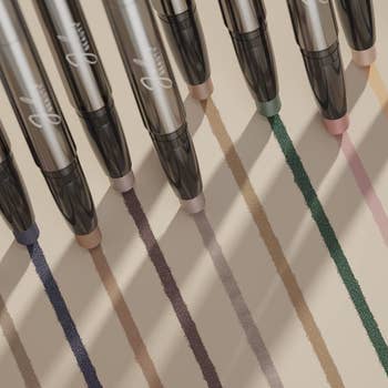 nine eyeshadow sticks being swatched on a surface