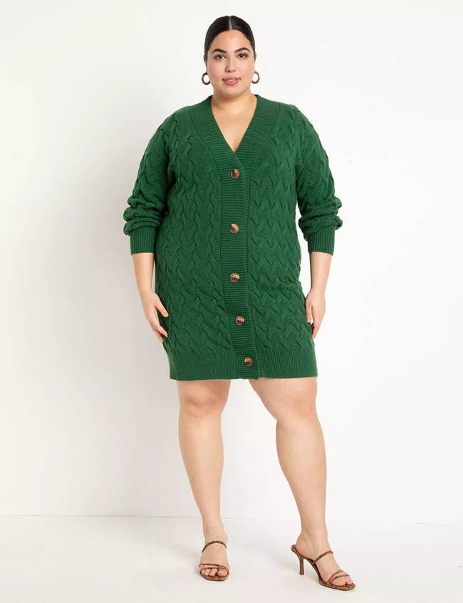 model wearing the green sweater dress with a heeled sandal
