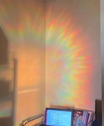 the rainbows cast on the wall above a desk from the prismatic film