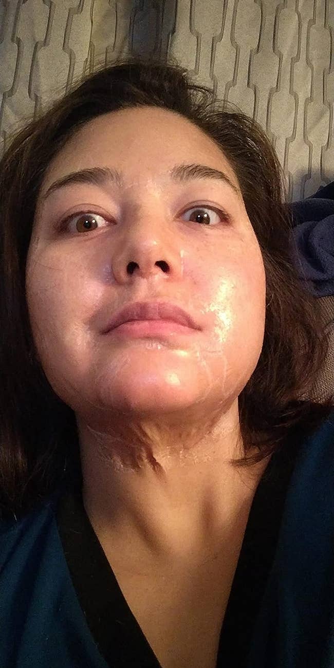 reviewer wearing a zombie-like skincare mask