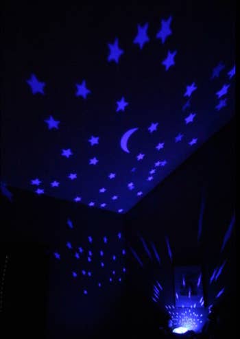 reviewer image of stars projected onto the walls of a dark room with the doll