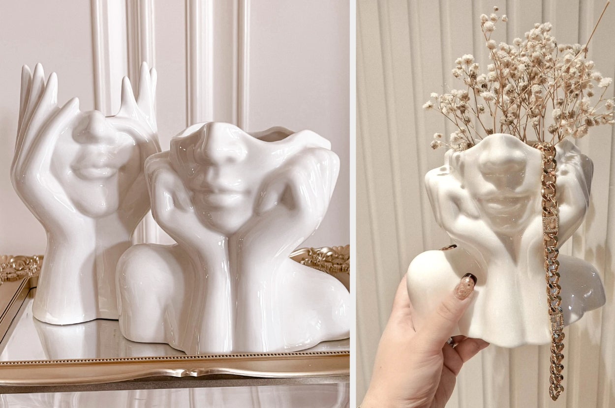 Two face-shaped white ceramic vases on top of golden frame, model holding one of the products with dried flowers and a gold chain inside
