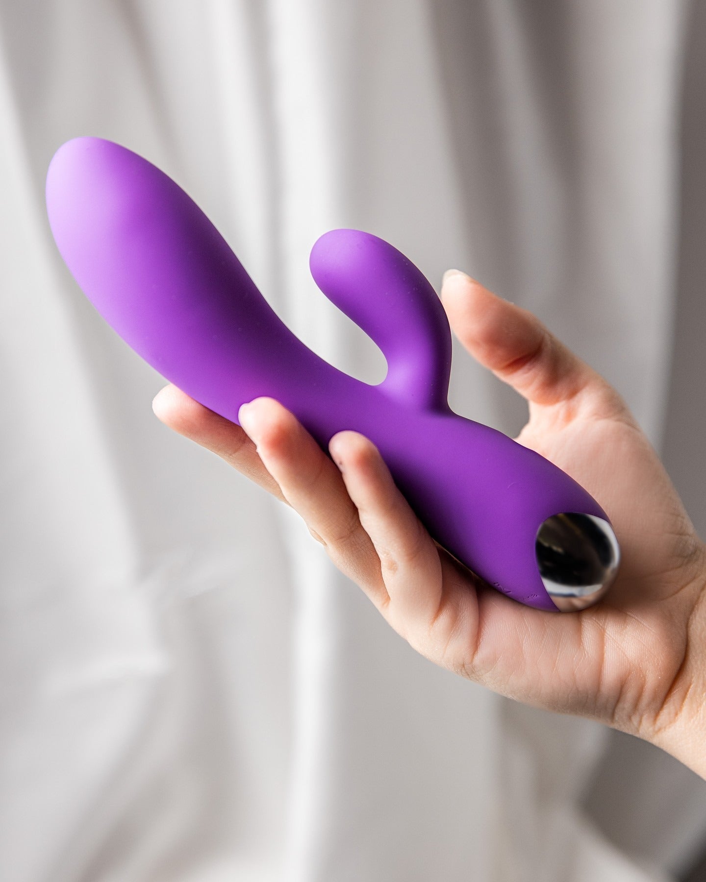hand holding purple rabbit vibrator