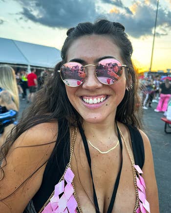 reviewer wearing the sunglasses at a music festival