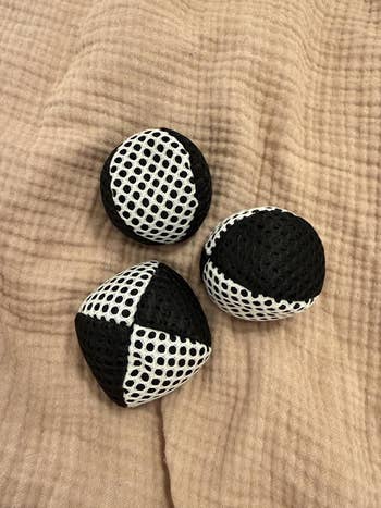 Three textured juggling balls with achromatic and achromatic mesh designs