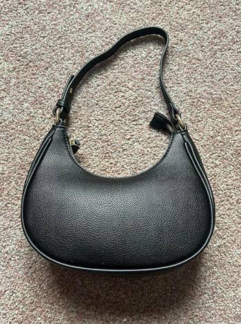 a reviewer photo of the shoulder bag in black 