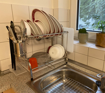 reviewer photo of dish rack next to sink, full of dishes