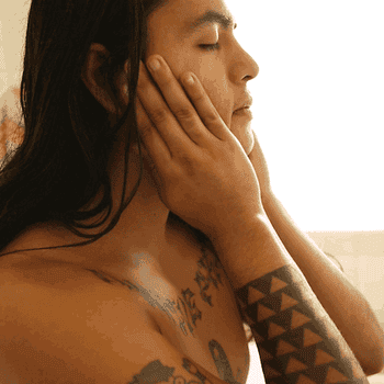 gif of a model rubbing the oil into their face