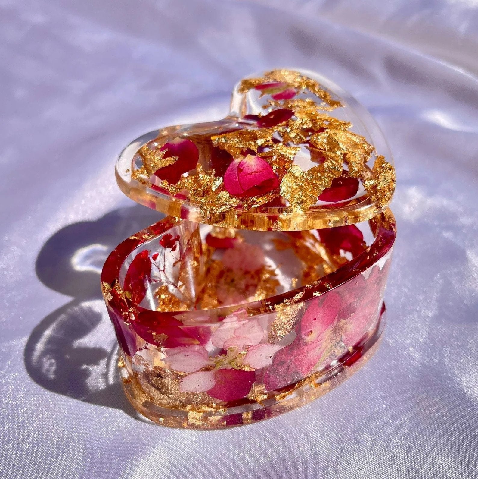A gold and red, resin heart-shaped trinket box