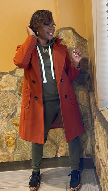 A reviewer wearing an orange coat