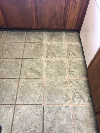 Tile flooring successful a kitchen; the grout for the near 2 rows is acheronian and dirty, the grout connected the close is cleanable and airy grey