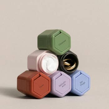 a set of six multicolored containers stacked in a pyramid