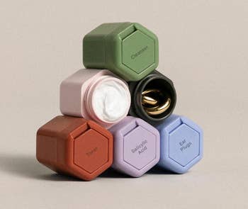 A set of six multicolored containers stacked in a pyramid