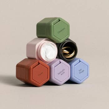 a set of six multicolored containers stacked in a pyramid