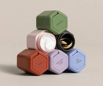 a set of six multicolored containers stacked in a pyramid