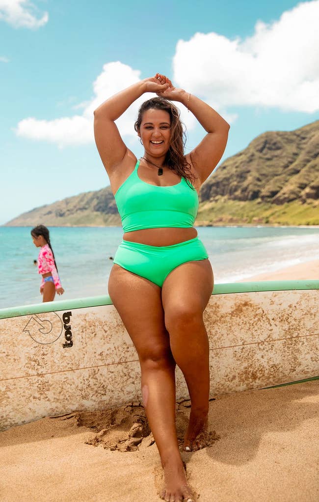 a model wearing a two piece bathing suit in bright green