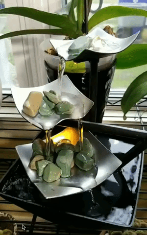 gif of water trickling down three tier waterfall