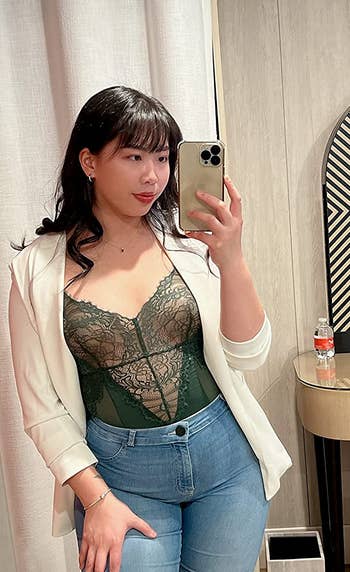 reviewer posing in see through top with pasties underneath