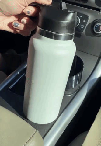 GIF of someone placing Hydro Flask into car cup holder adapter