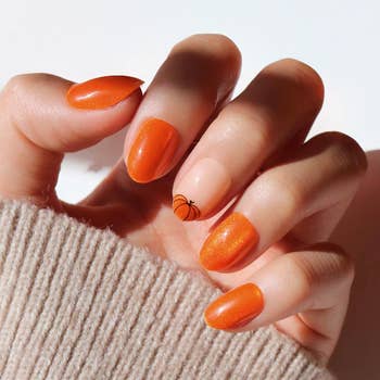 A exemplary  wearing the pumpkin-themed property   connected  nails