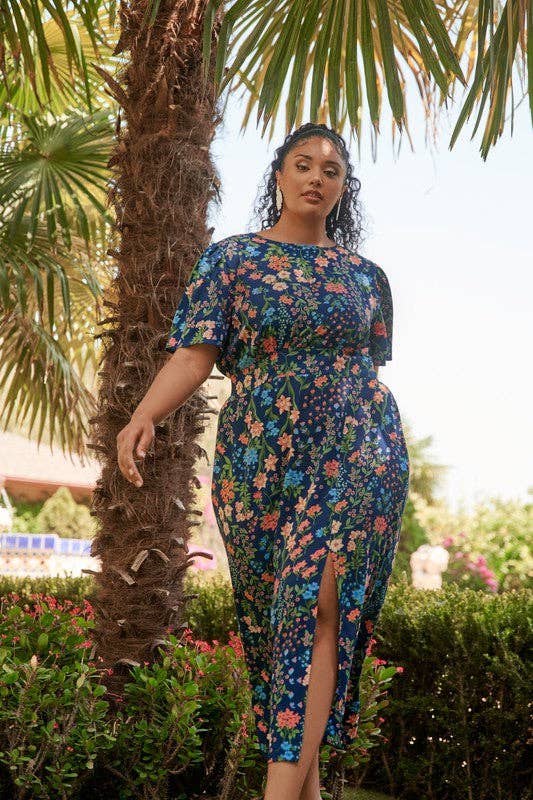 model in navy short sleeve dress with colorful floral print and side slit
