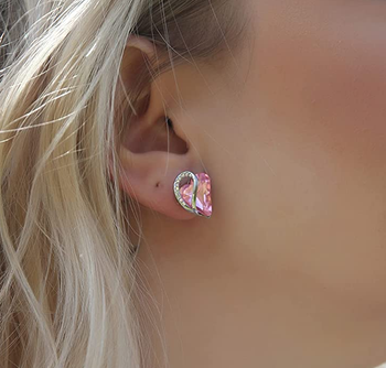 Model wearing the pink heart earrings