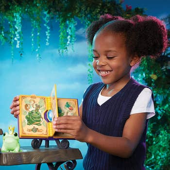 Child model showing plastic book from magic set 