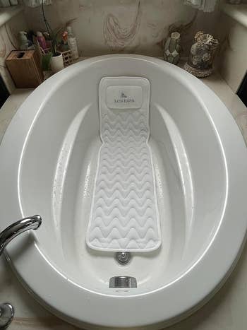 a long body bath pillow in a tub