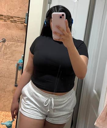 reviewer wearing the black top