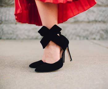 Reviewer in black stiletto heels with a wraparound bow at the ankle 