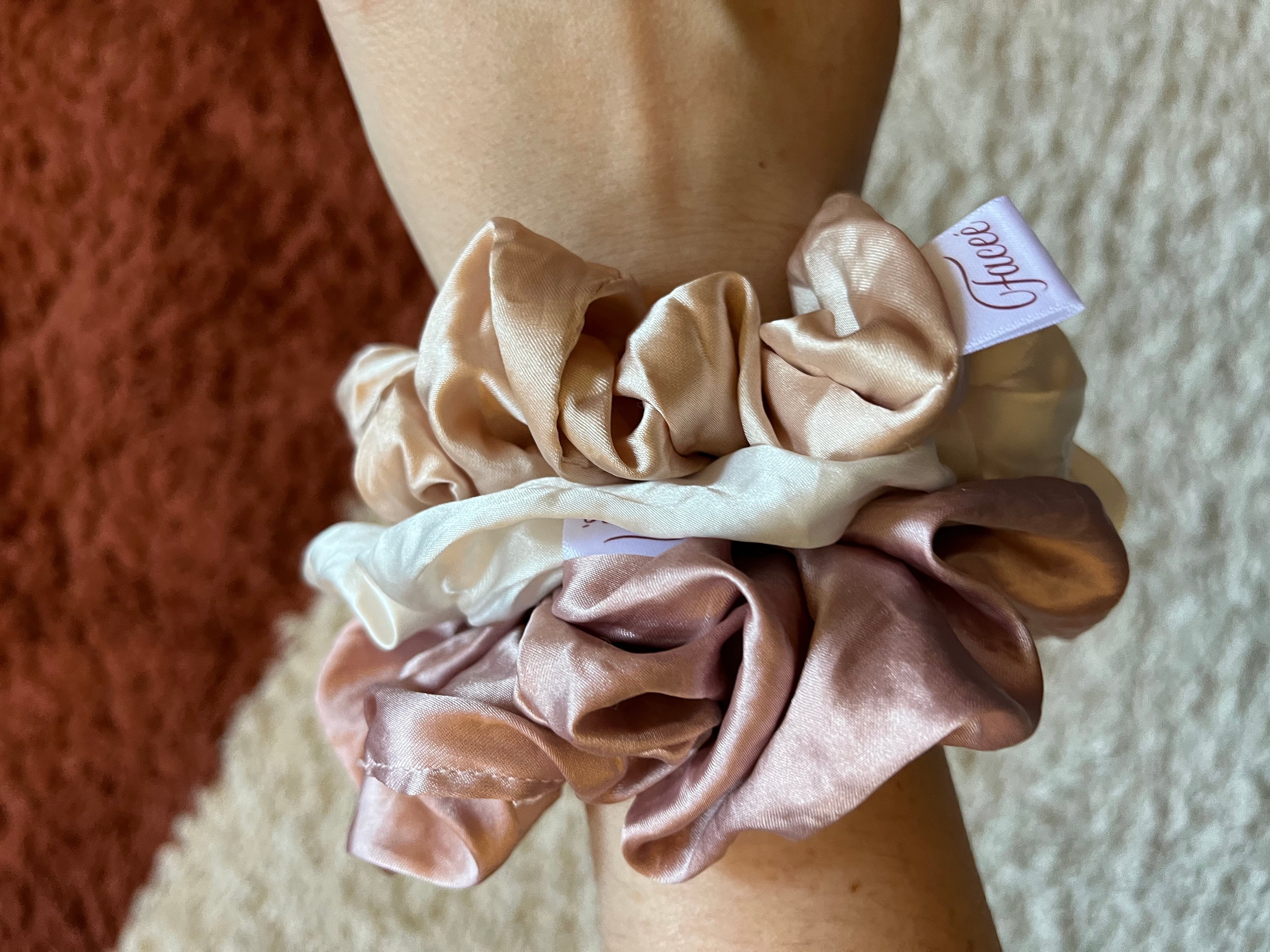 pink and white scrunchies on BuzzFeed editor Whitney Jefferson's wrist