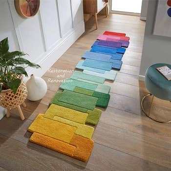 Colorful rug  in a gradient display ranging from blues to greens to yellows