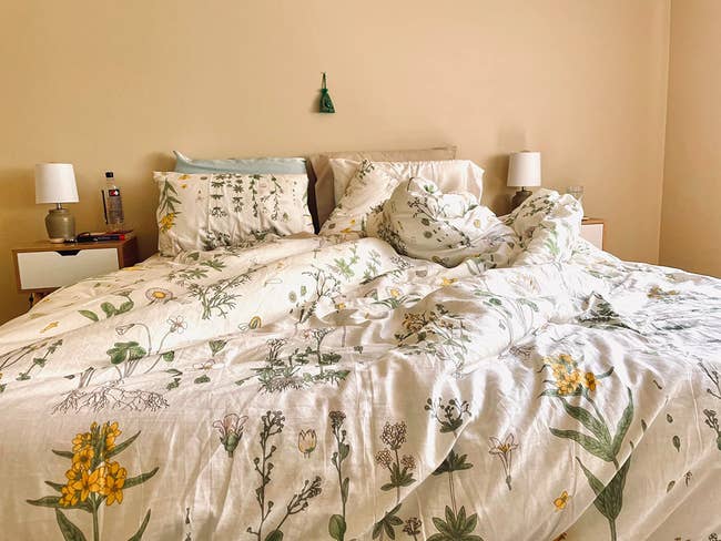 a reviewer's bed with the floral comforter and pillow cases covered in yellow flowers and other small florals