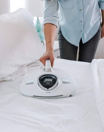a model uses the vacuum on bed sheets