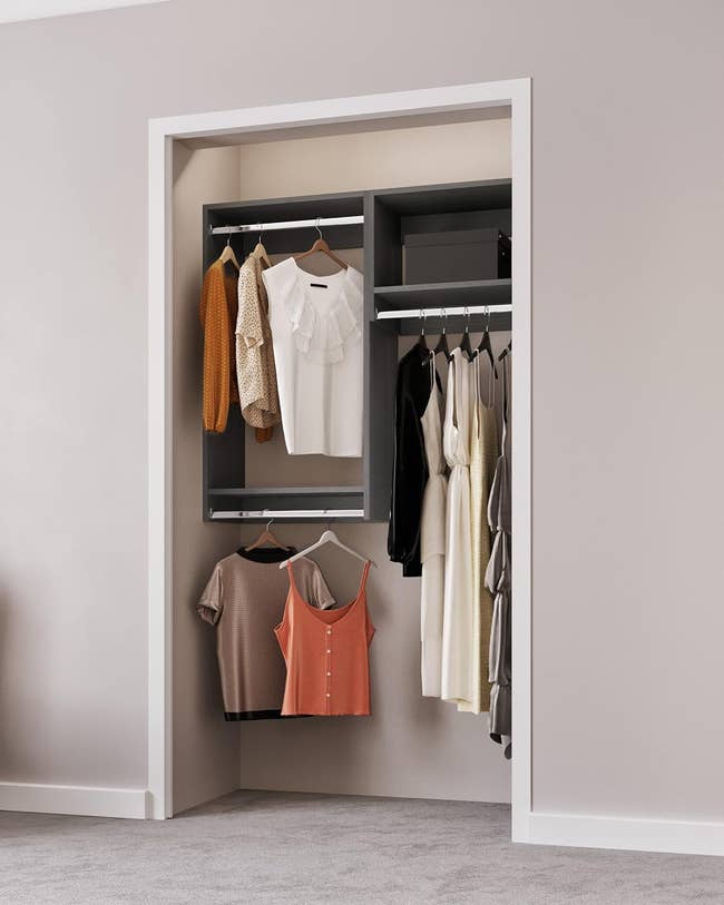 A well-organized closet with wooden shelves and metal rods