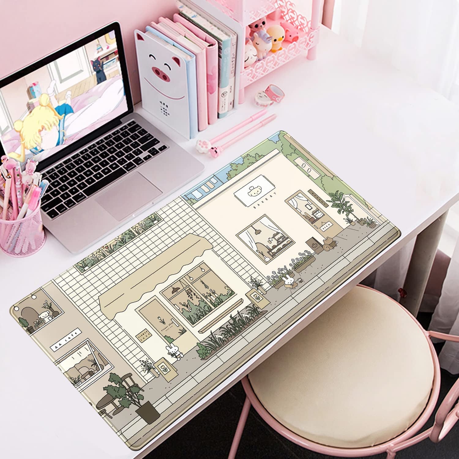 a desk pad with a cute illustration on it of a bakery, coffee shop, and florist.