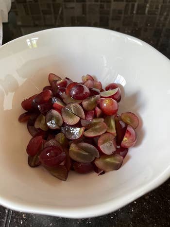 reviewer's bowl of quartered grapes