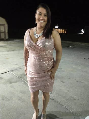 Reviewer wearing ruched rose gold sleeveless dress