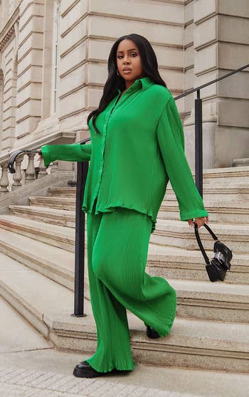 Model walking in the green pants and matching long-sleeve top