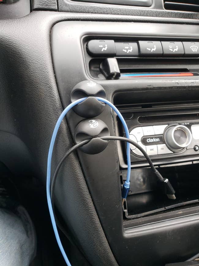 Two cable holders attached to reviewer's dash board holding chargers