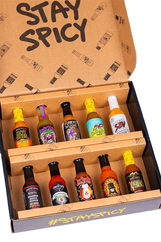 A variety of hot sauces in a box with 