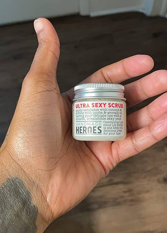 image of the small jar of lip scrub in the palm of a reviewer's hand