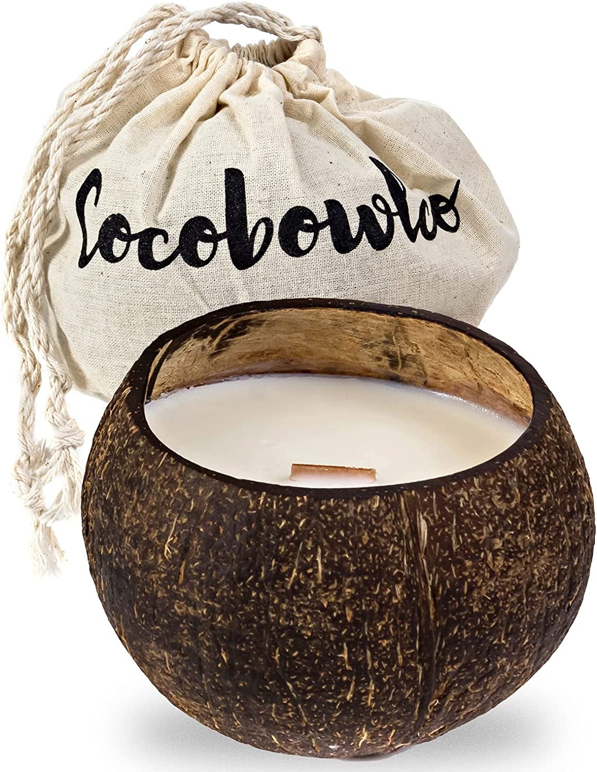 a coconut shell candle in front of a canvas pouch