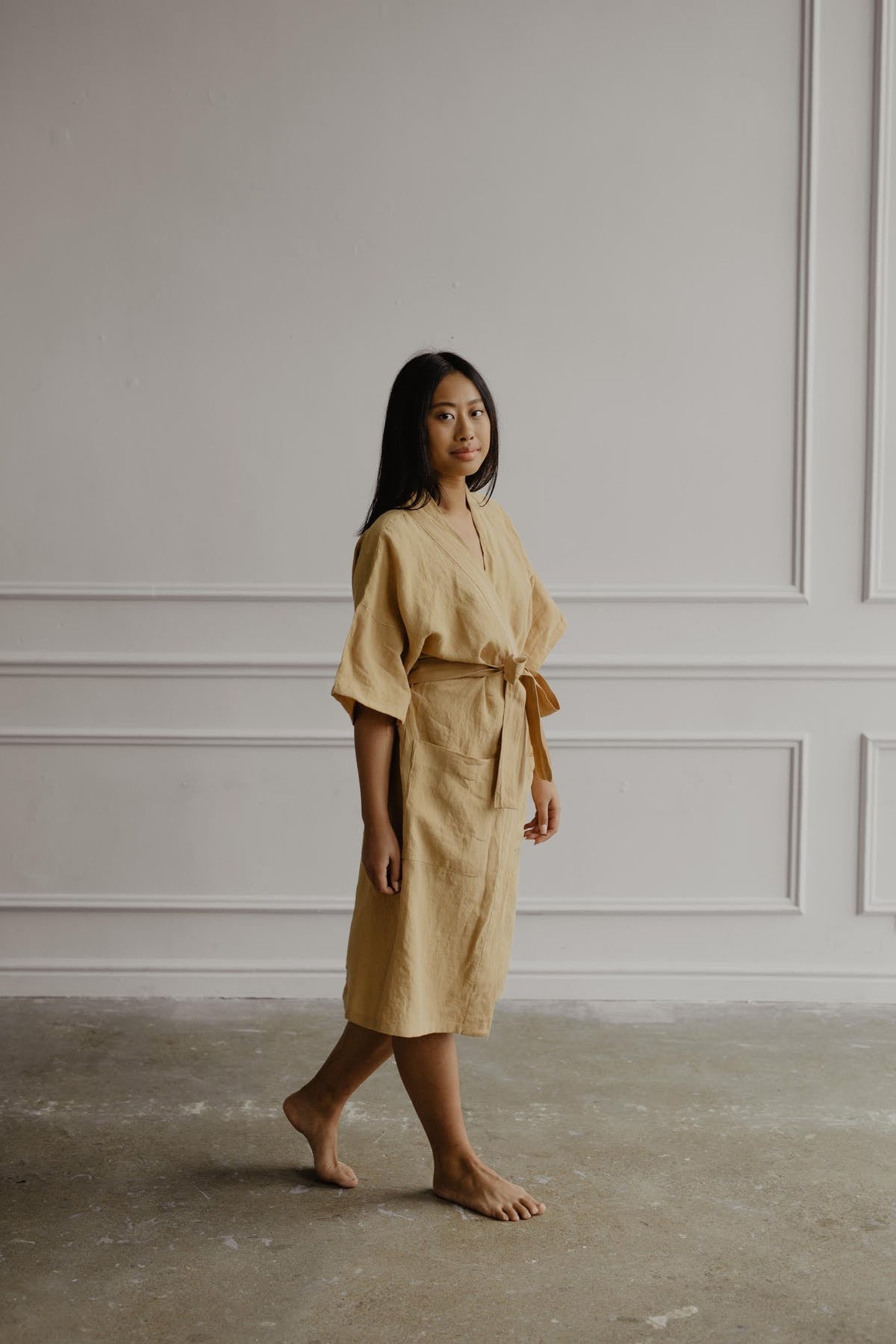 A model in the robe in the color mustard
