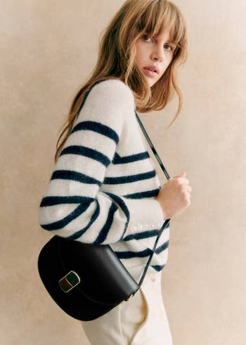 side view of model in blue and white striped sweater