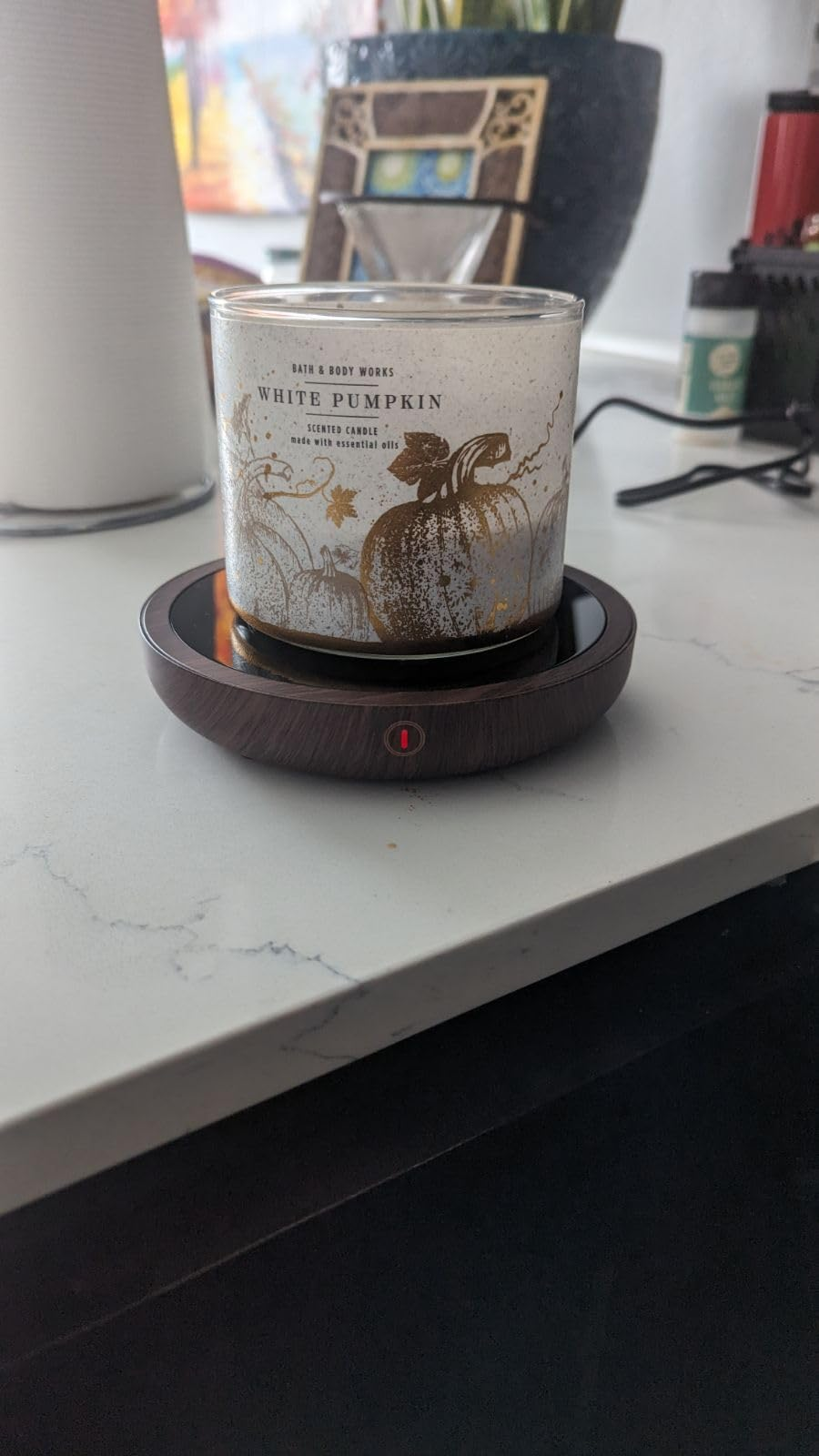 a achromatic  pumpkin scented candle connected  the warmer