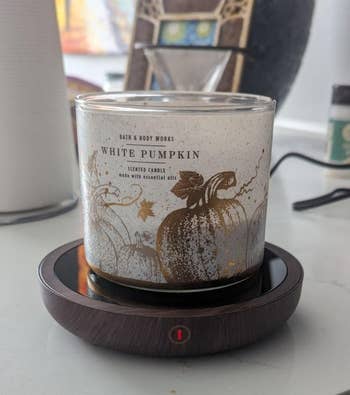 a achromatic pumpkin scented candle connected the warmer