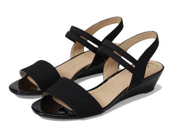 Black wedge sandals with a peep-toe plan and wide ankle straps, suitable for casual oregon semi-formal wear